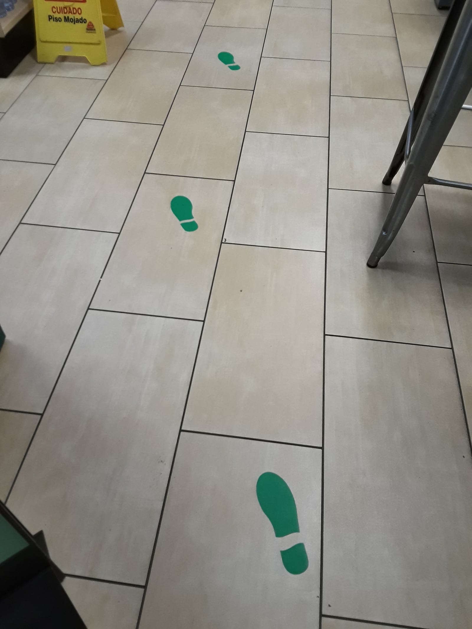 Interior of a 7-Eleven store, floor leading toward the refrigerated food shelves.