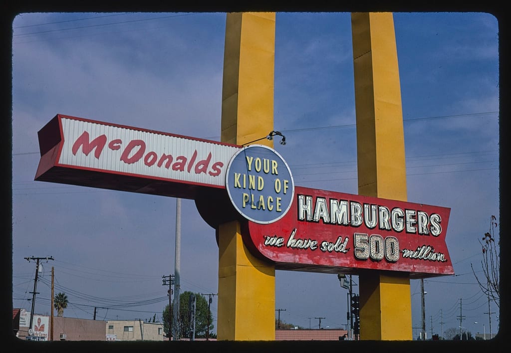 A vintage McDonald's sign reading 'Your Kind of Place, Hamburgers, we have sold 500 million' at the Downey, California location
