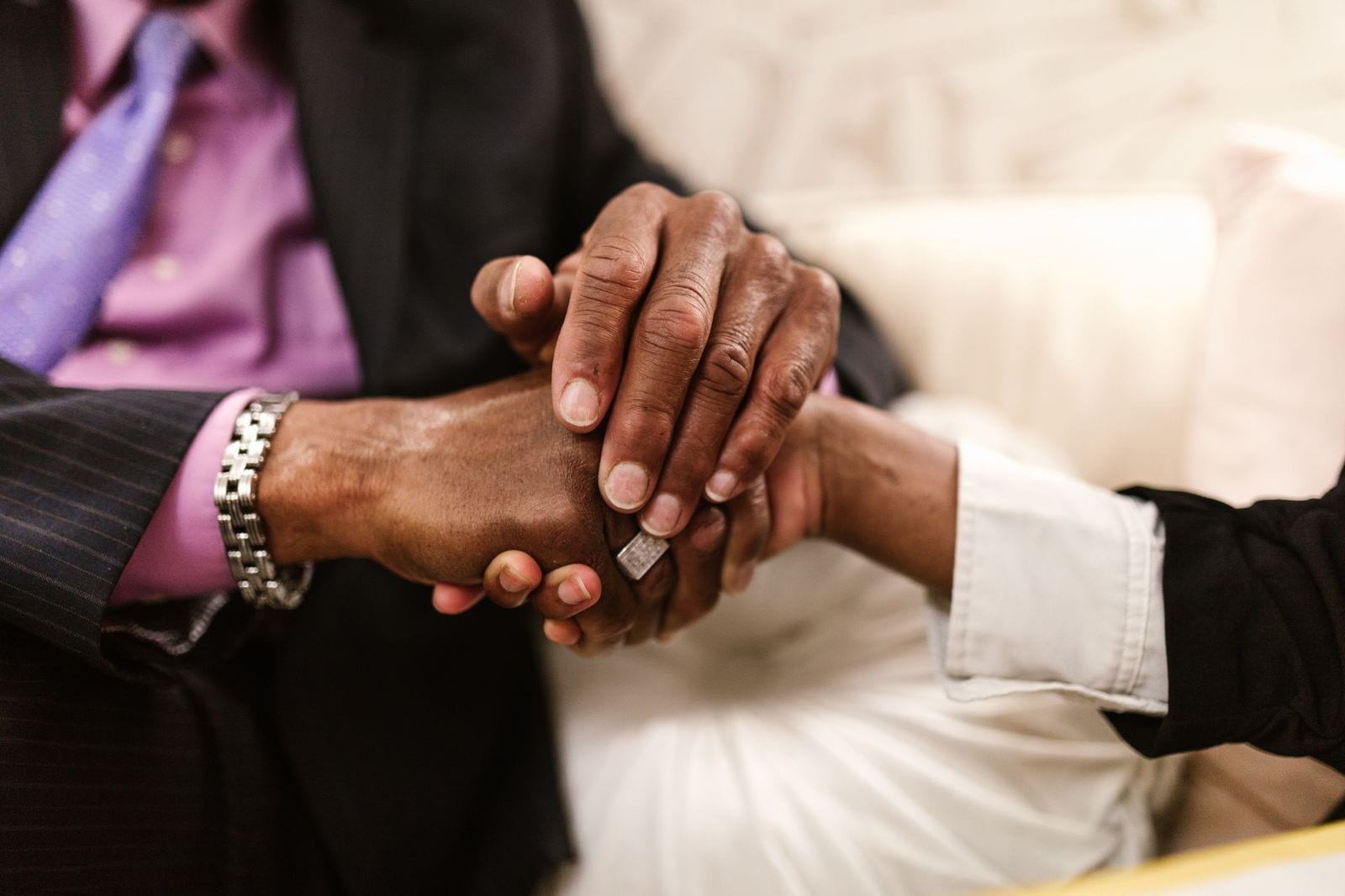 Two business partners shaking hands over a signed agreement