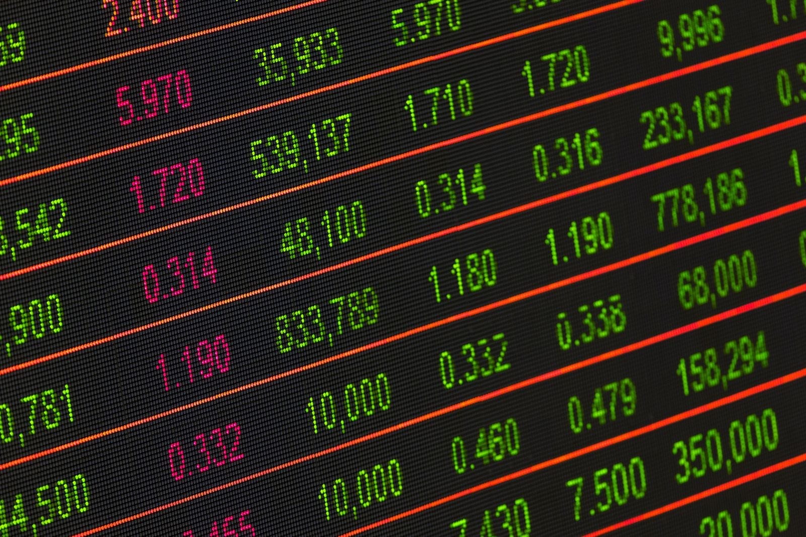 Close-up of a digital stock market ticker board showing rows of price and volume data